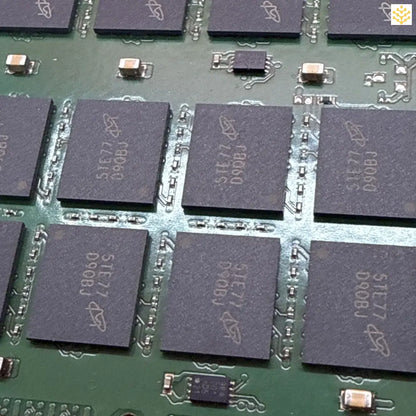 Memory chips mounted on a green circuit board.