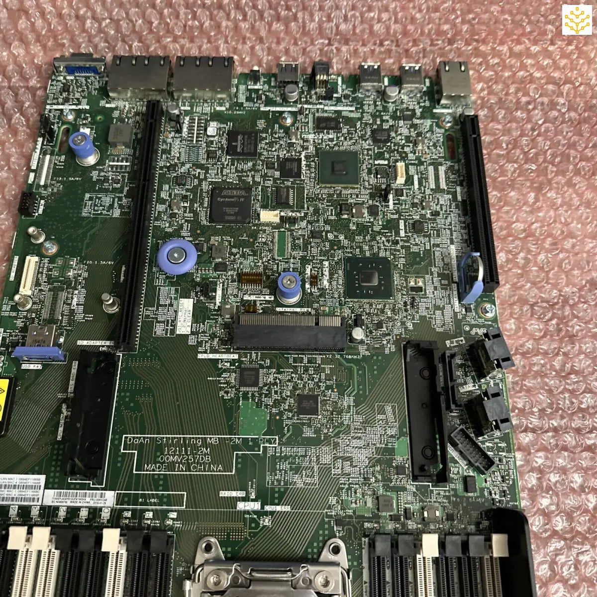 Computer motherboard with integrated circuits, ports, and components mounted on a green PCB.