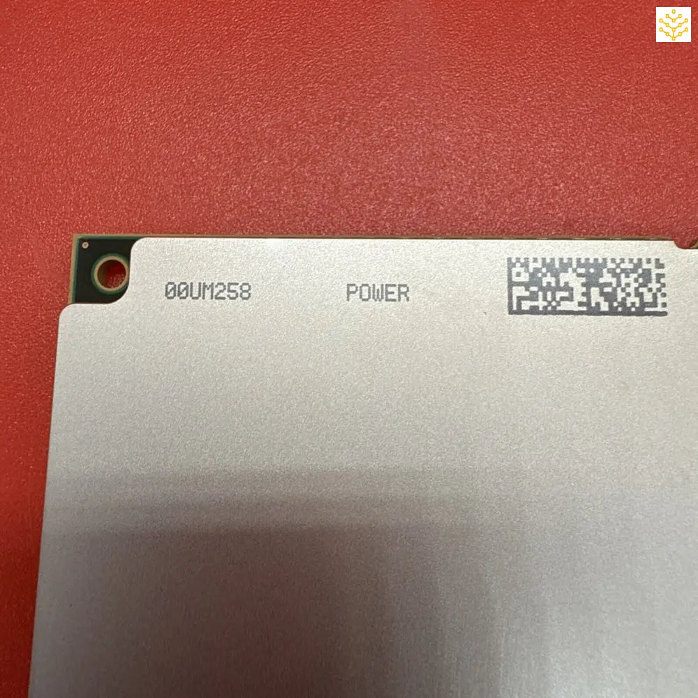 White electronic component or circuit board with printed text and a QR-style code.