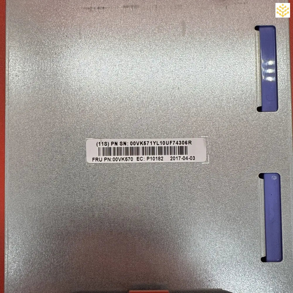 Silver metallic computer or electronic device panel with a barcode label and purple accents.