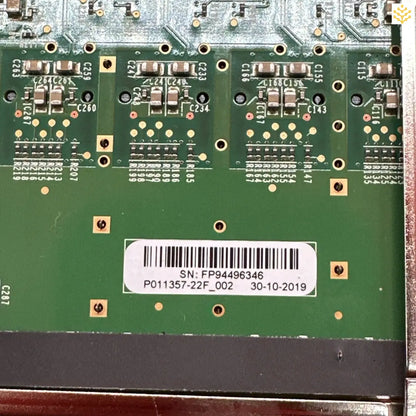 Circuit board with electronic components and a barcode label.