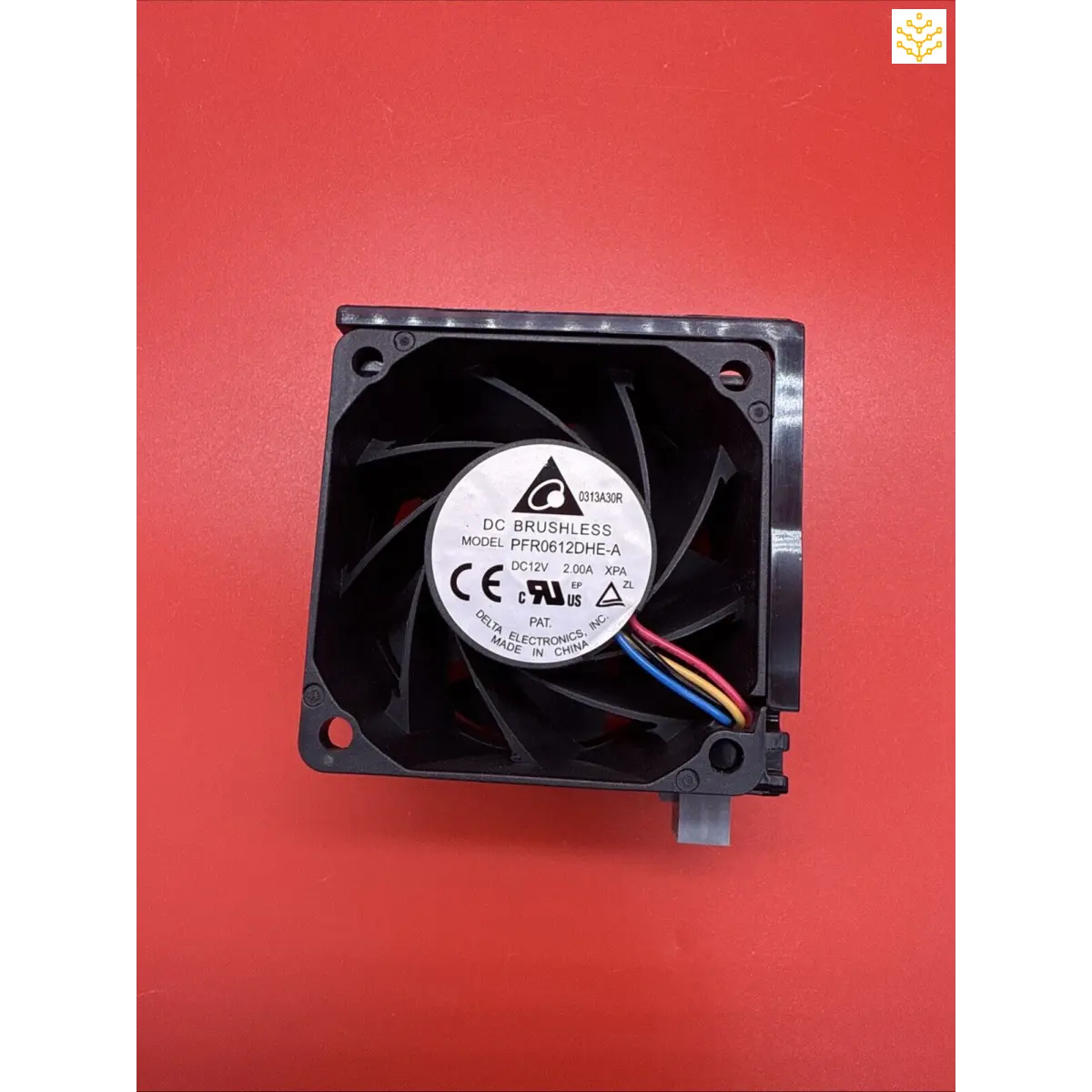 Computer cooling fan with visible blades and multicolored wires.