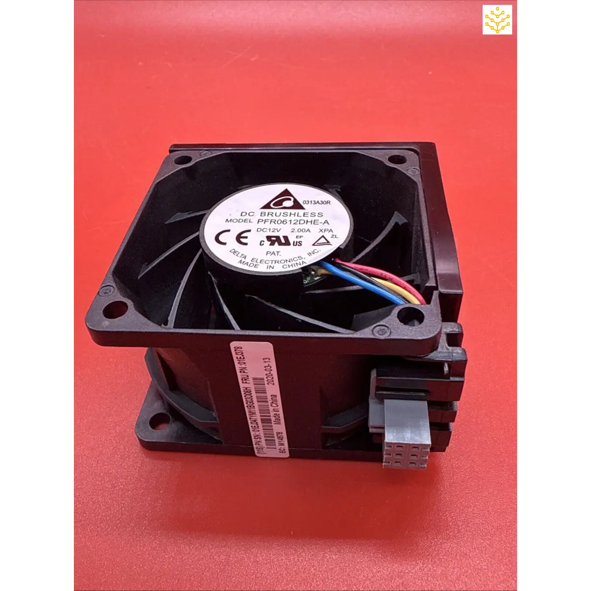 Computer cooling fan with visible wires and manufacturer label.