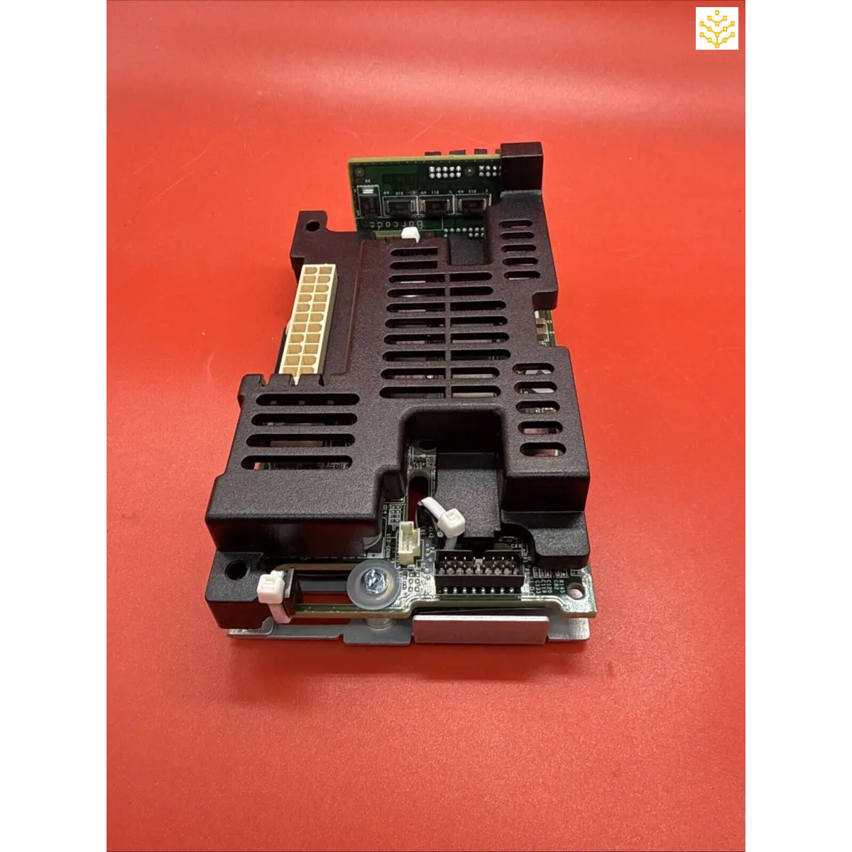 Black electronic circuit board module with heat sink fins and connector ports.