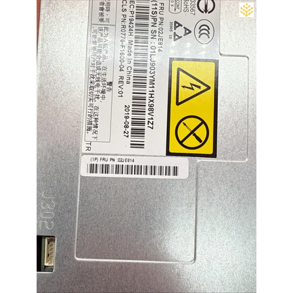 Electronic device or component with warning labels and a barcode sticker attached.