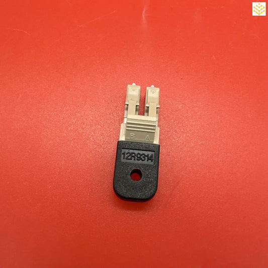 Electronic component or connector with a black base and two white prongs.