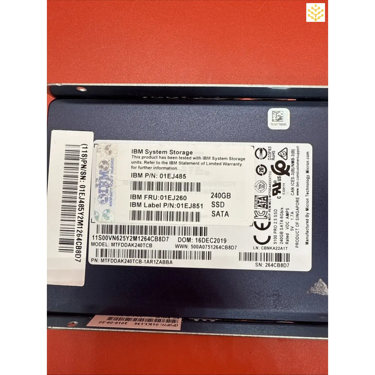 Solid-state drive (SSD) with IBM branding and technical specifications visible on its label.