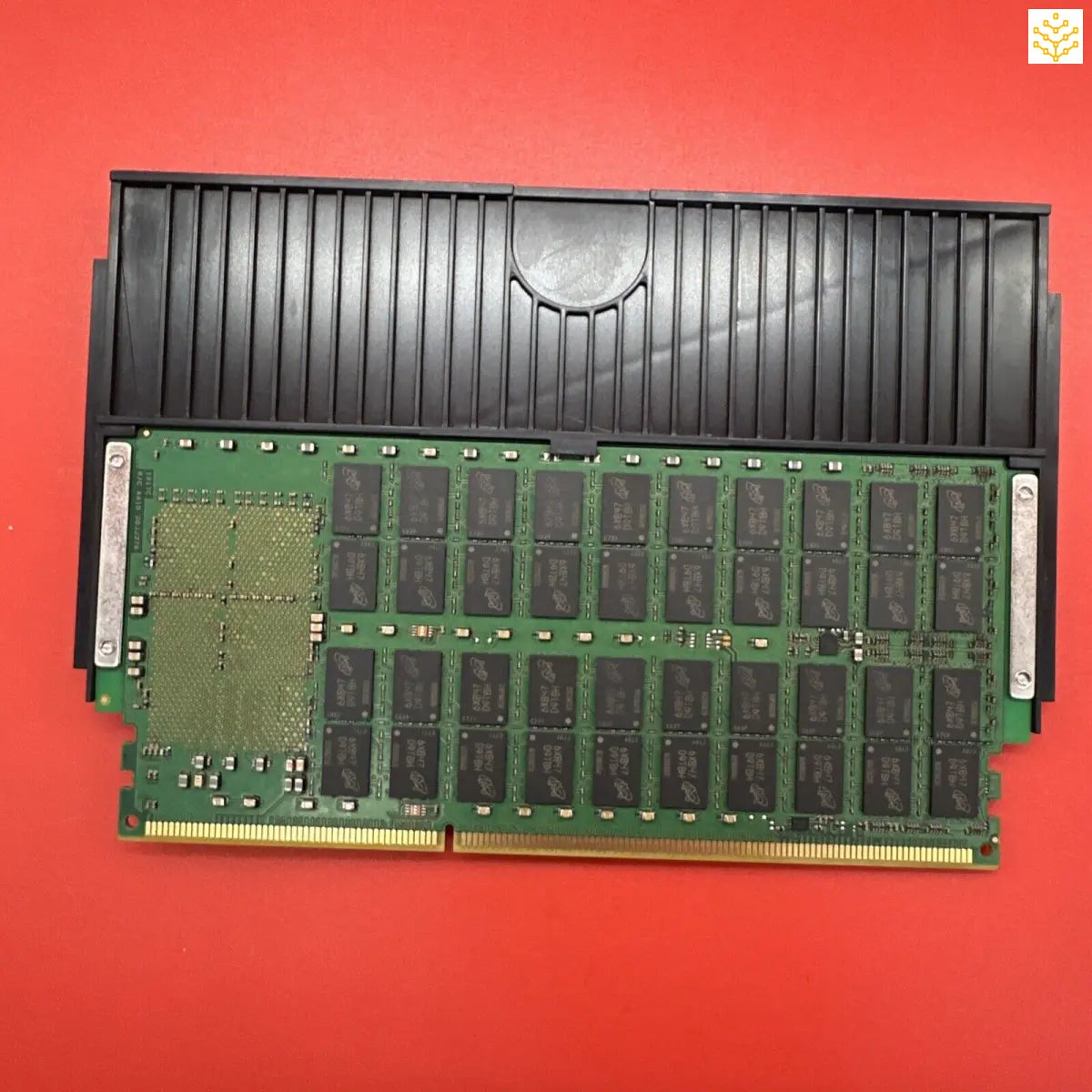 Computer RAM module with a black heat spreader attached.