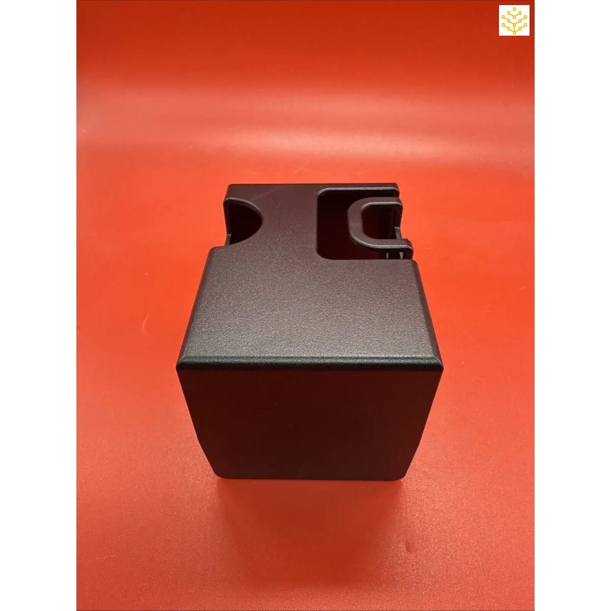 Black plastic cube-shaped container with notched corners.