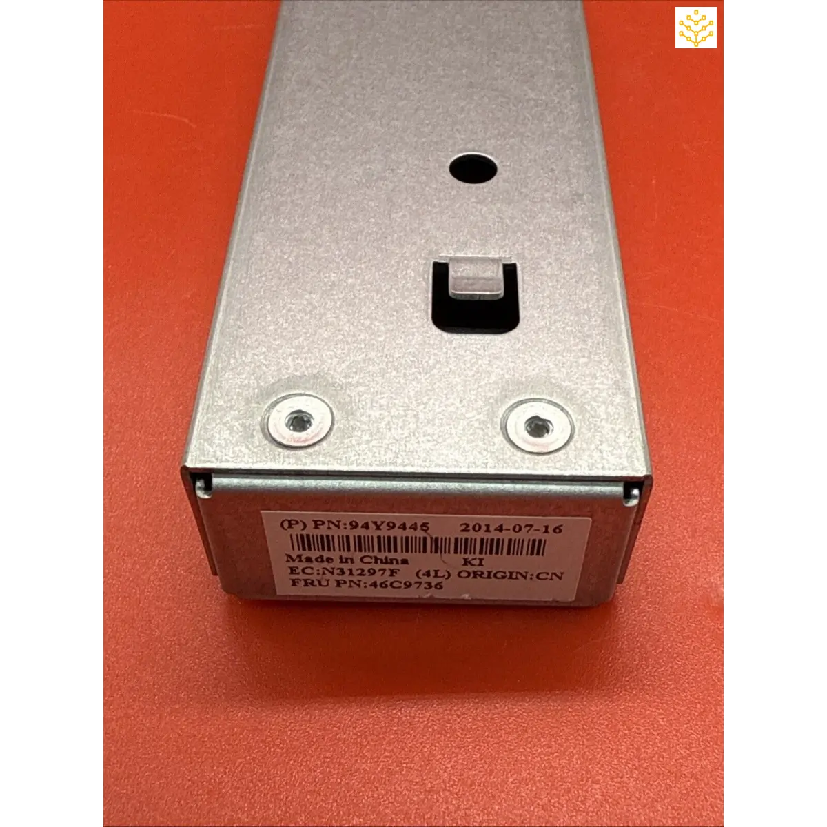 Metallic silver power supply unit with mounting screws and a barcode label.