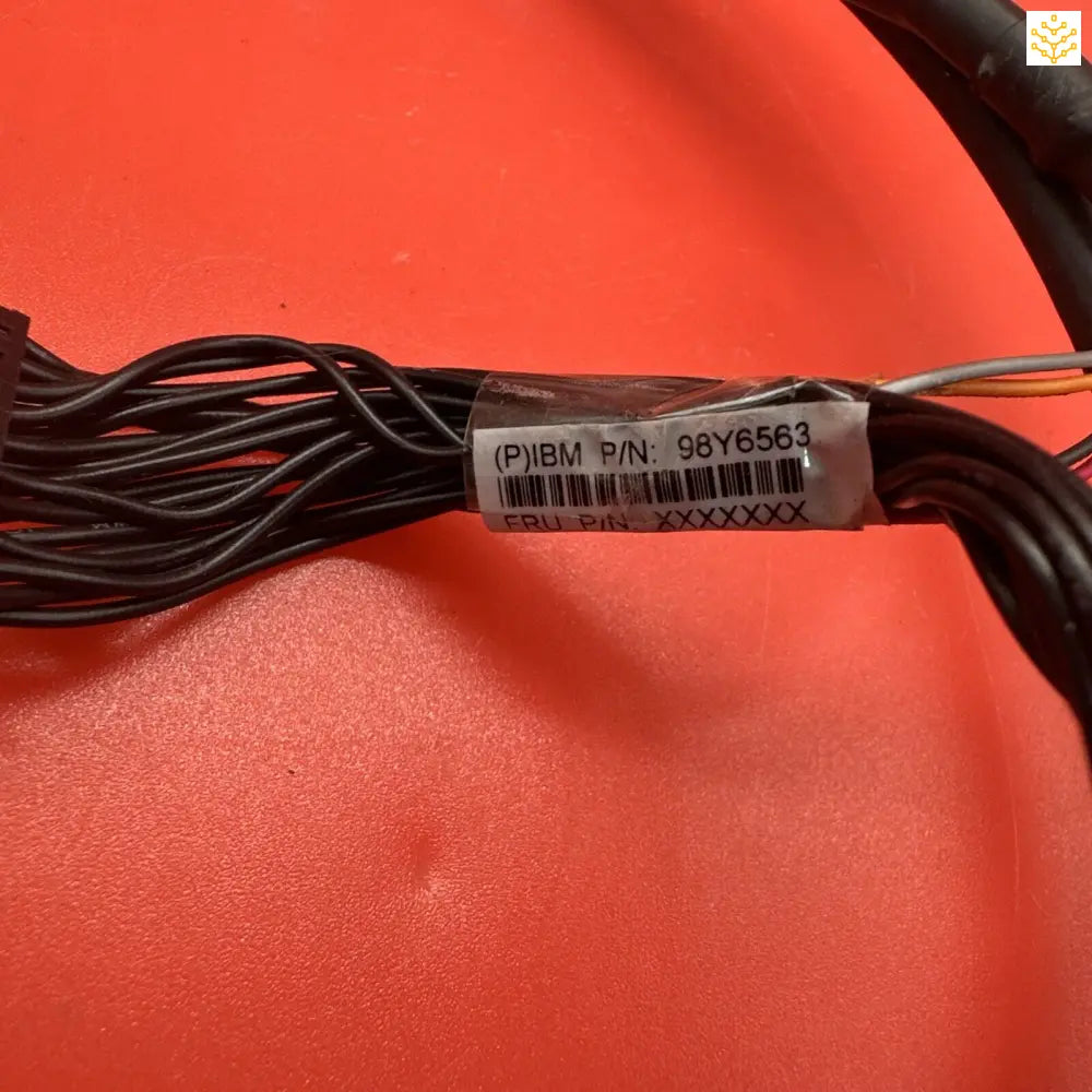 Black electrical cord with a label tag attached.