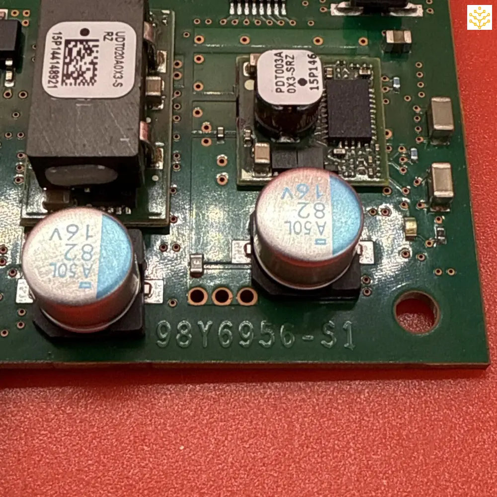 Circuit board with electronic components including capacitors and integrated circuits.