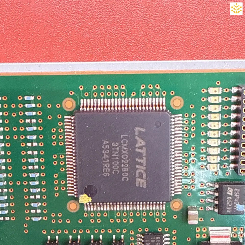 Lattice integrated circuit chip mounted on a green circuit board.