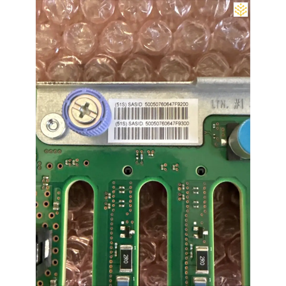 Circuit board with RAM slots and serial number labels.