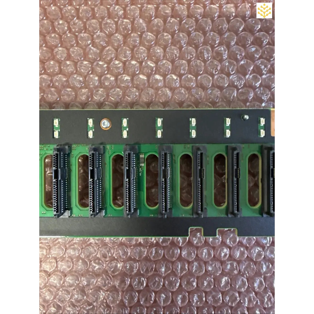 Circuit board with parallel black memory slots or expansion ports mounted on green PCB material.