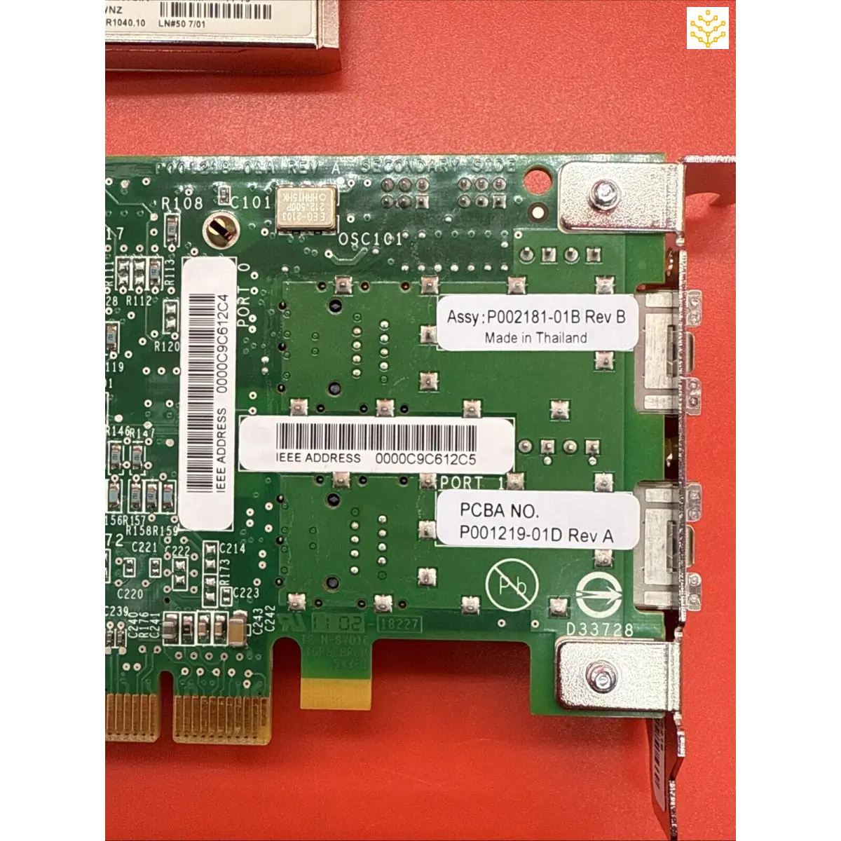 Green PCB circuit board with electronic components and mounting screws.