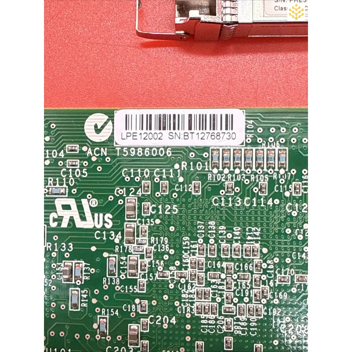 Circuit board with visible electronic components and a barcode.