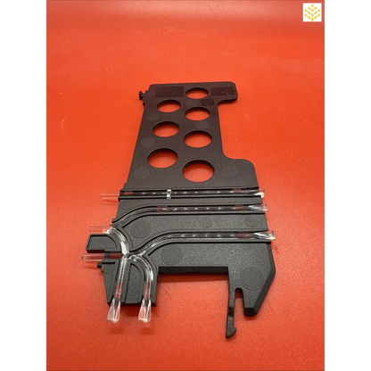 Black plastic track piece with multiple circular holes and curved rail sections.