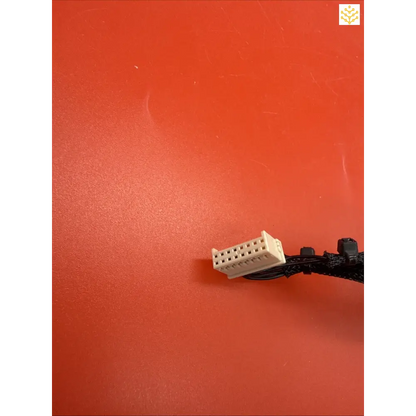 White plastic LEGO brick attached to a black cable.