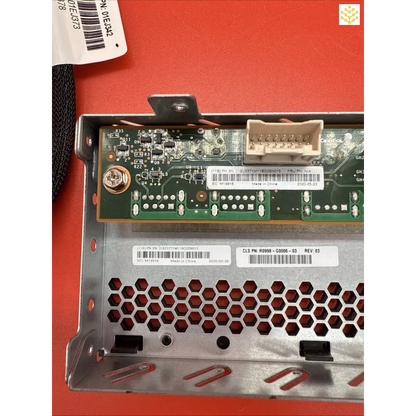 Circuit board with electronic components mounted on a metal bracket with hexagonal ventilation holes.