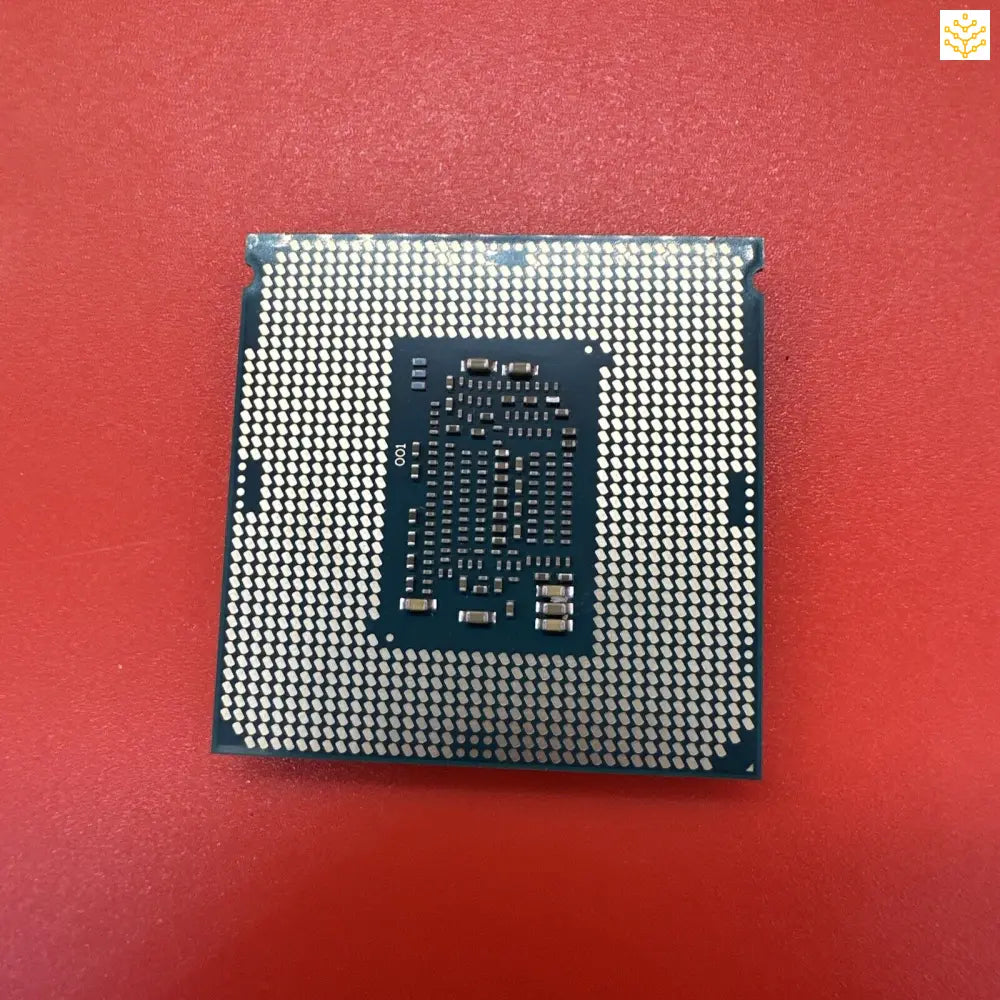 Computer processor chip with visible pin grid array on its underside.