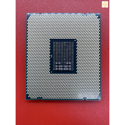 Computer processor chip with a grid of metallic contacts on its surface.