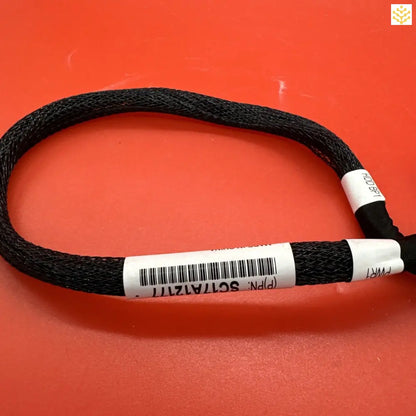 Black braided cord or cable with white labeled tags attached.