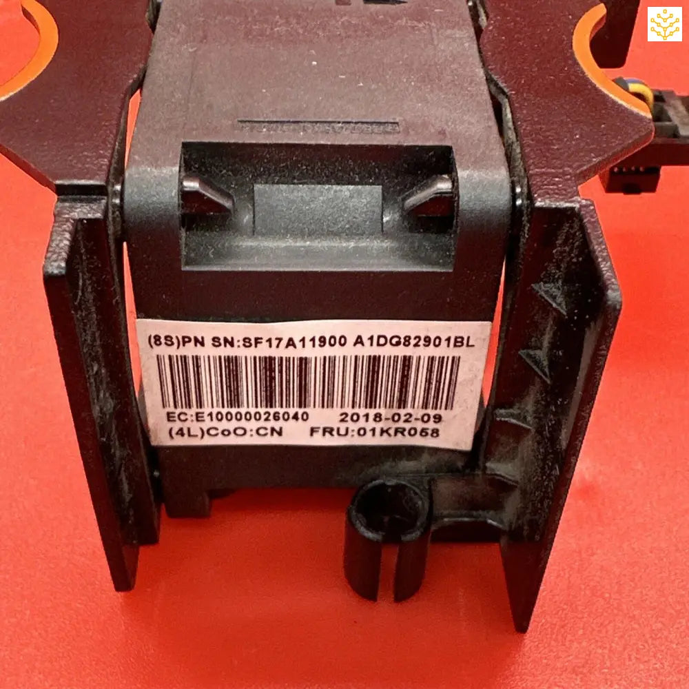 Electronic component or module with a barcode label and serial number visible.