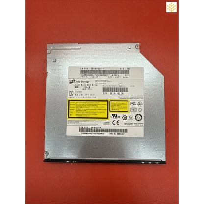 Internal laptop DVD/CD optical drive with silver metal casing and yellow warning labels.