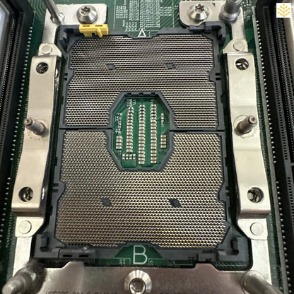 CPU socket on a computer motherboard with visible pins and mounting brackets.