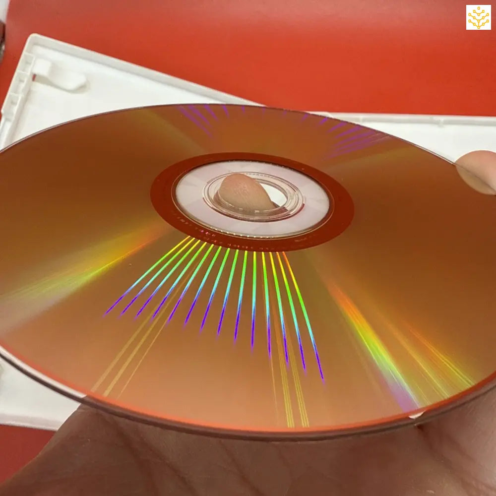 Compact disc (CD) displaying rainbow light reflections across its surface.