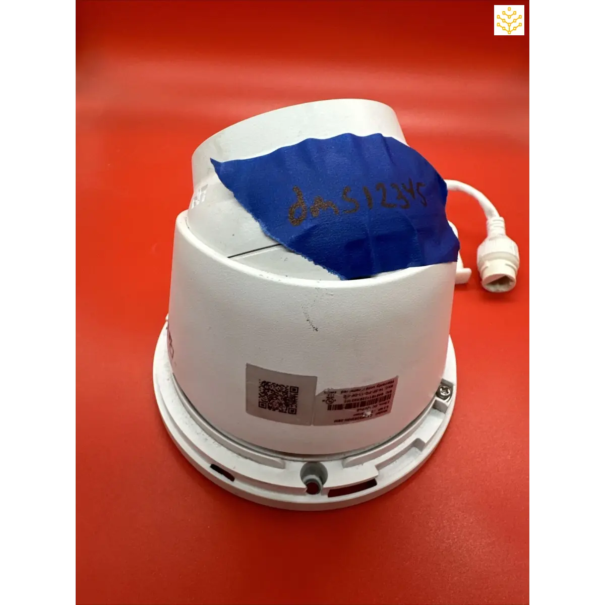 White plastic bucket-like device with a blue interior and an attached cord.