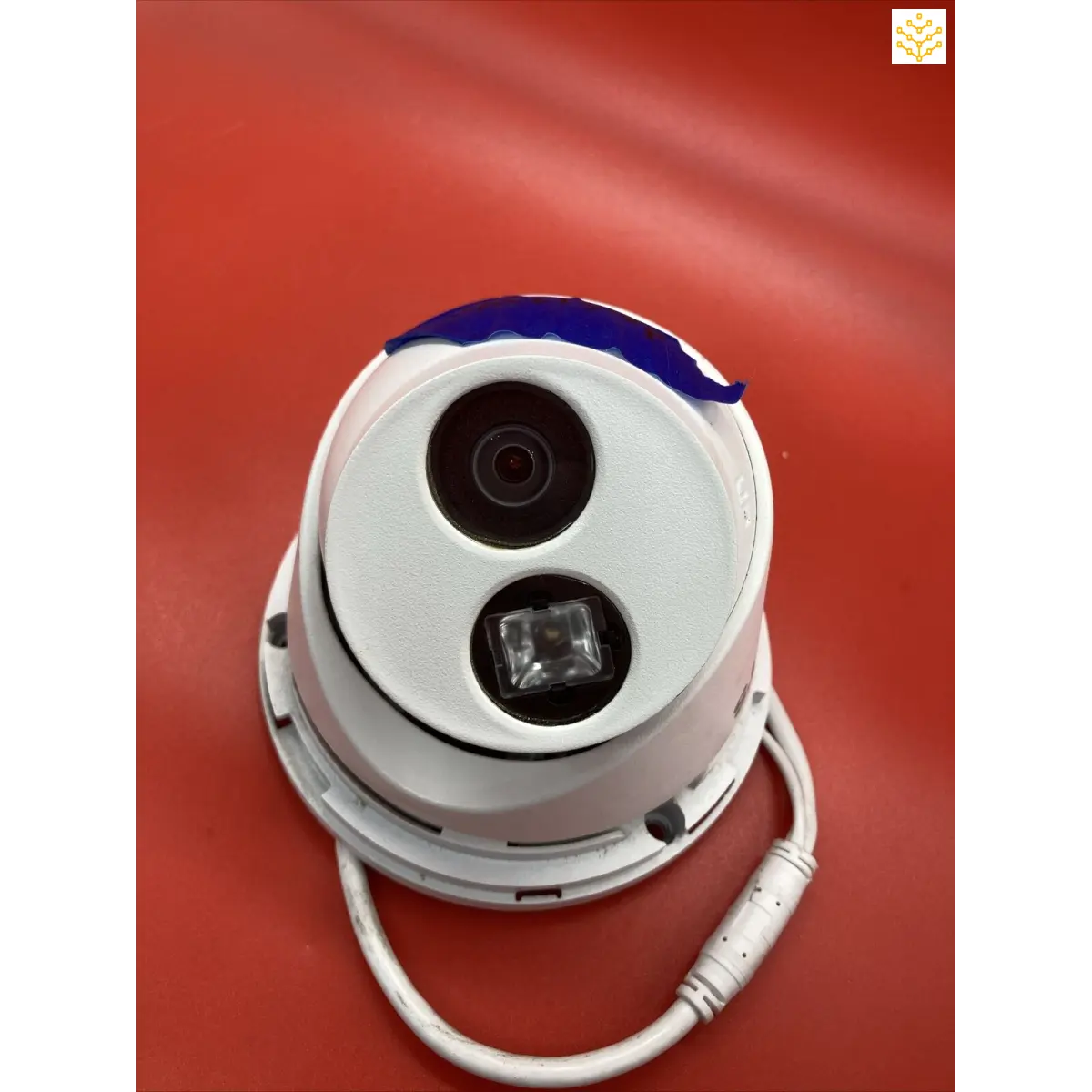 Security camera with a dome-shaped housing and two visible lenses.