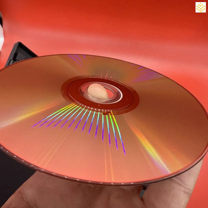 Compact disc (CD) displaying rainbow light reflections across its surface.