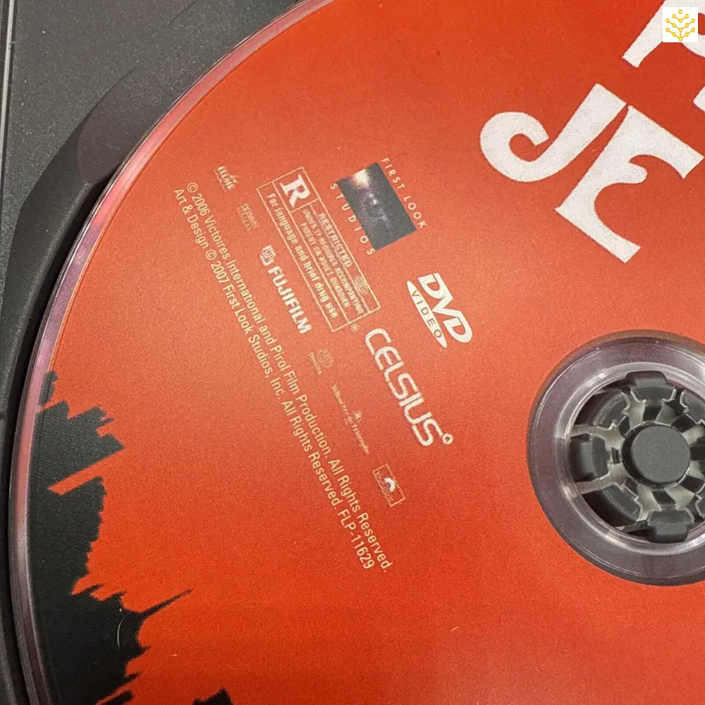 Red DVD disc with black silhouettes visible on its surface.