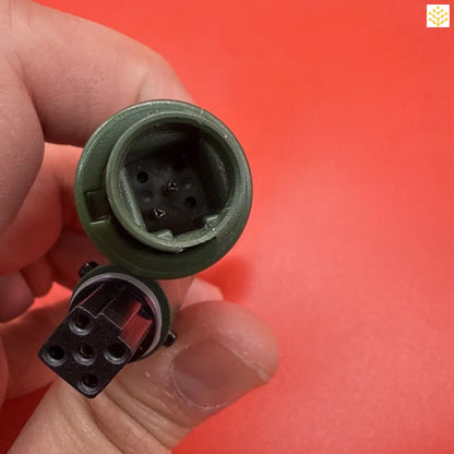 Disconnected electrical connector or socket with visible pin holes.