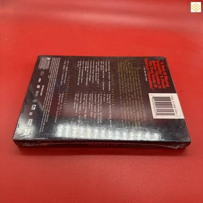 DVD or Blu-ray case with black cover and text on a red surface.