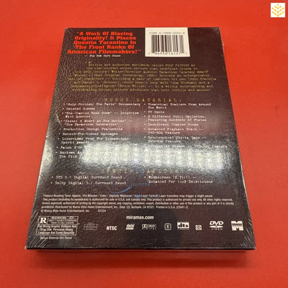 DVD box set with a dark cover against a red surface.