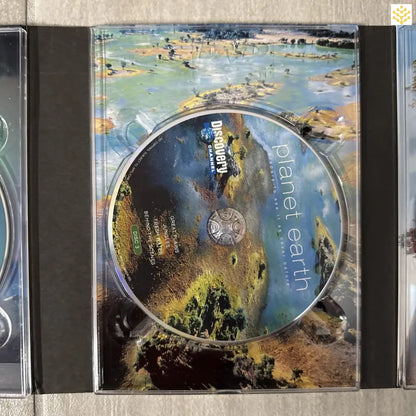 Compact disc with colorful nature-themed artwork visible on its surface.