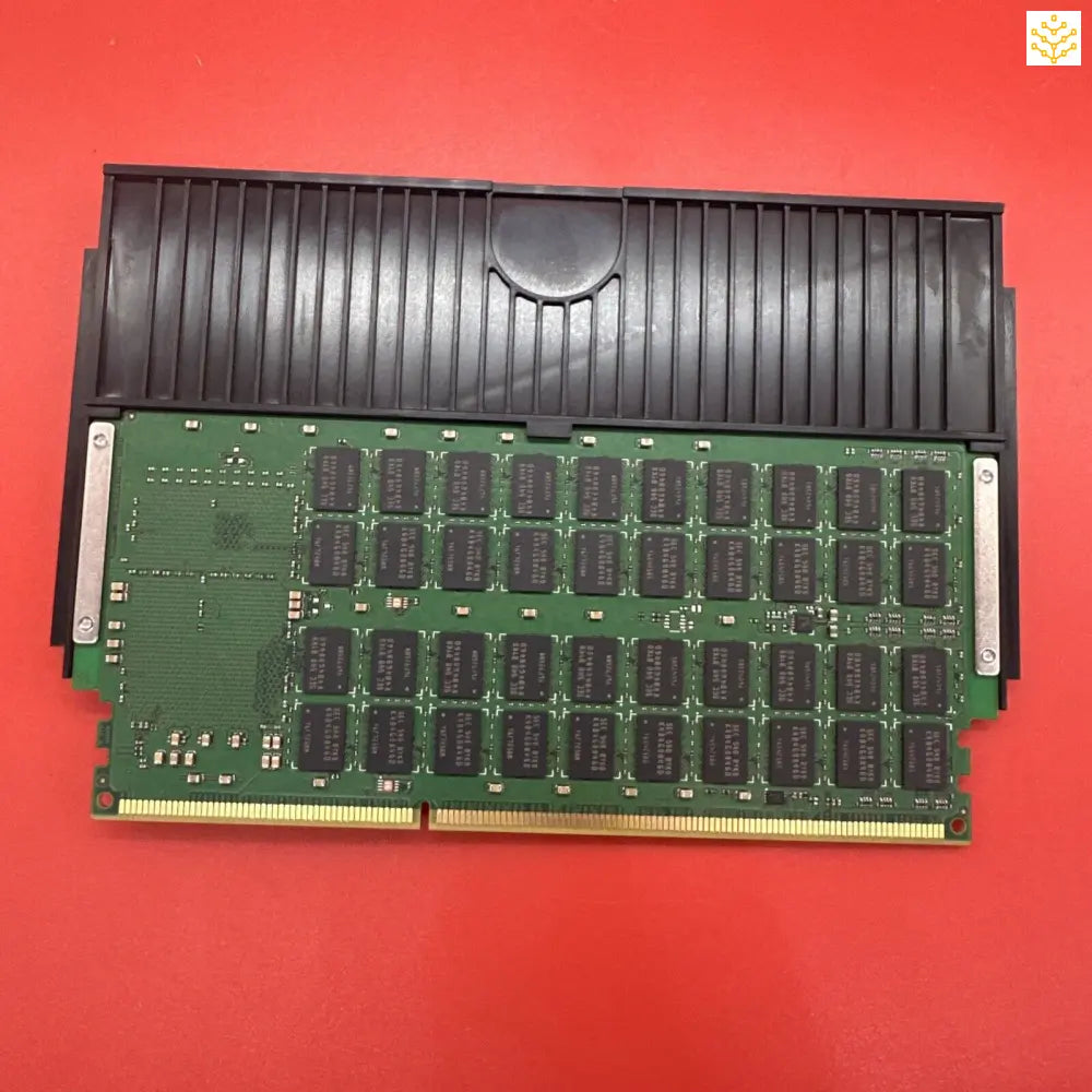 Computer memory module with black heat spreader and green circuit board.