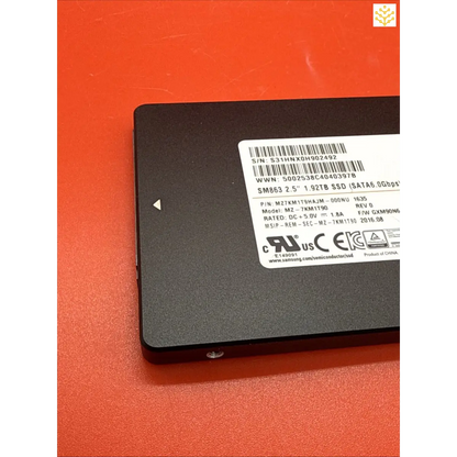 Solid-state drive (SSD) with a product label displaying technical specifications.