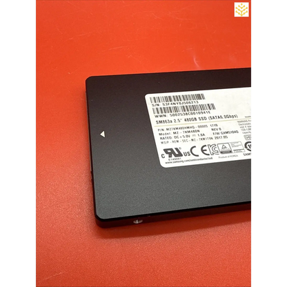 Solid-state drive (SSD) with a visible label containing technical specifications.