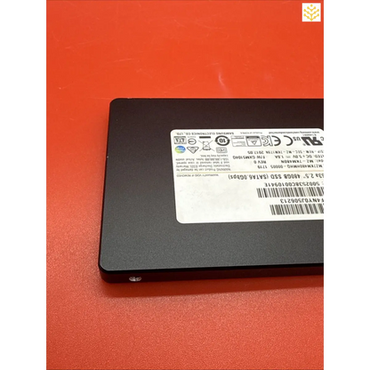 Solid-state drive (SSD) with a visible information label on its surface.