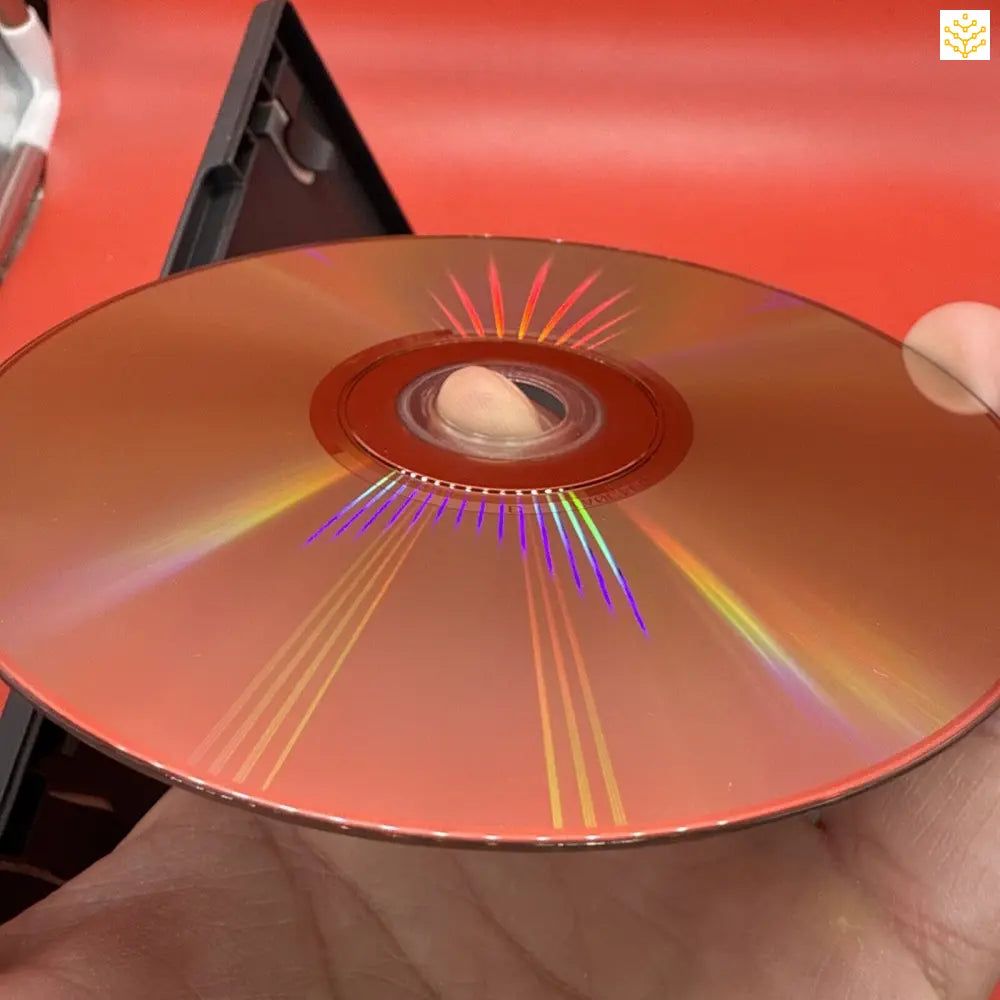 Compact disc (CD) displaying rainbow-like iridescent reflections on its surface.