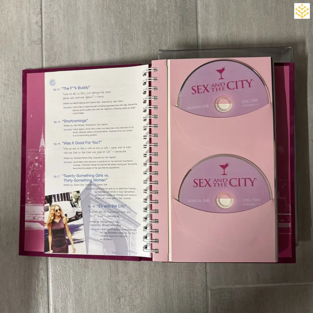 Open spiral-bound book showing ’Sex and the City’ DVD discs on the right page.