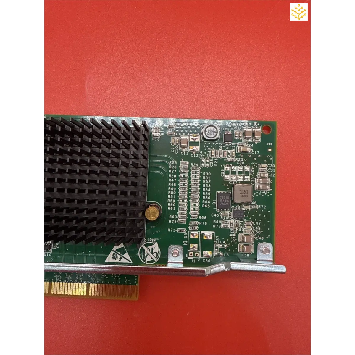 Computer expansion card with a green circuit board and black heat sink.