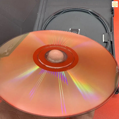 Compact disc (CD) reflecting rainbow colors on its surface.