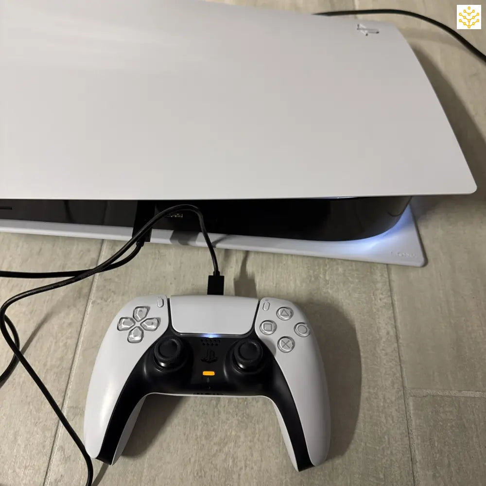 White PlayStation 5 gaming console with DualSense controller.