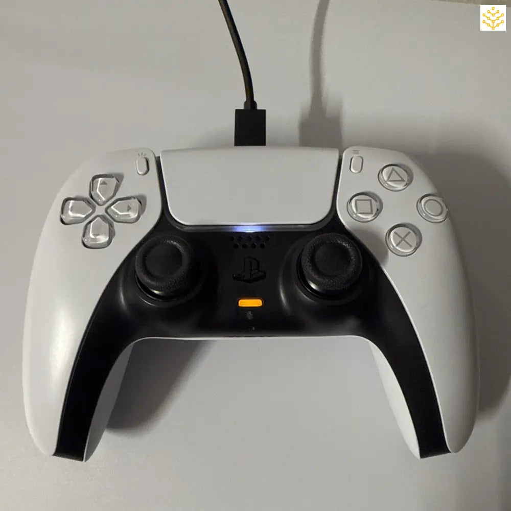 White and black PlayStation 5 DualSense wireless controller with illuminated touchpad.