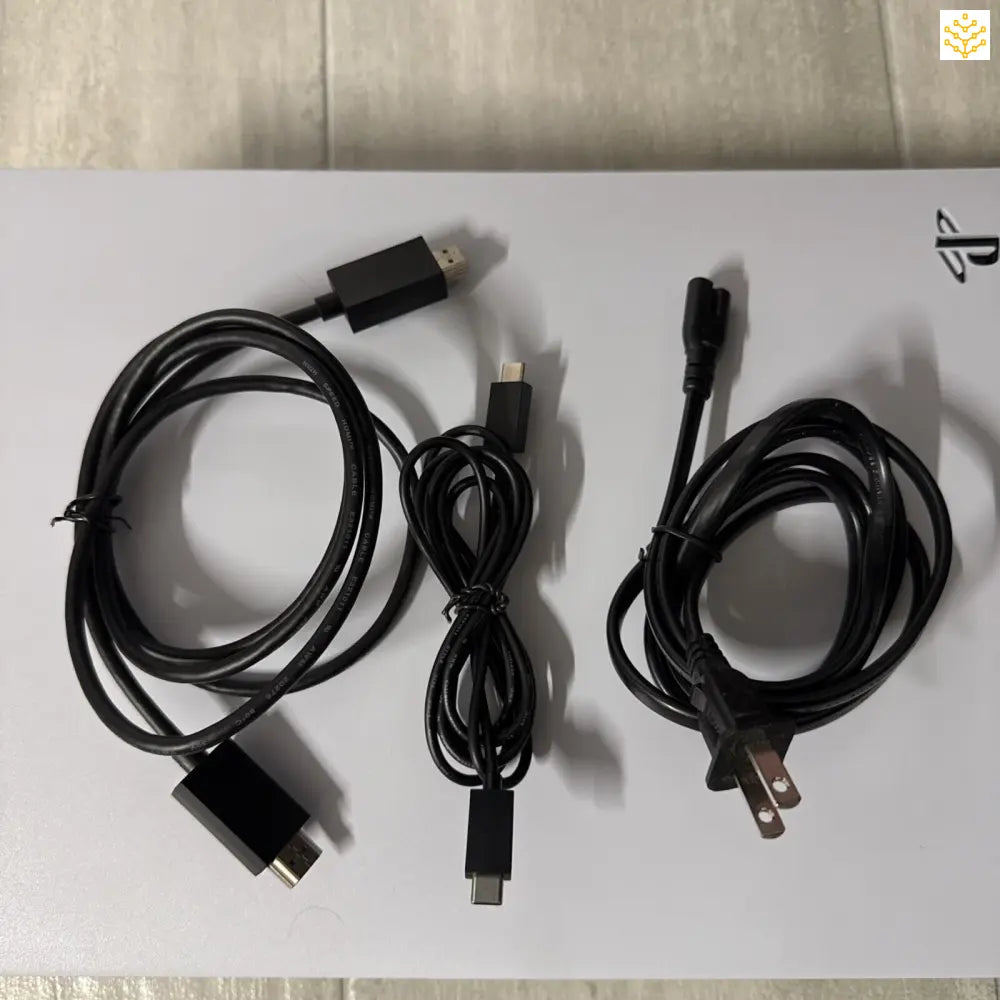 Three black USB or power cables coiled on a surface.